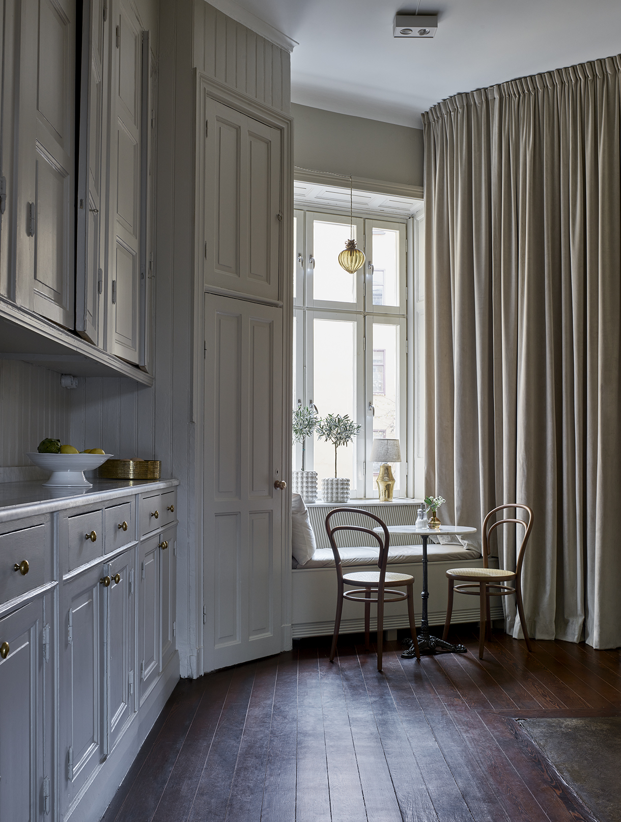 a kitchen with a table and chairs