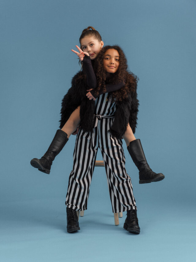 a girl holding a girl on her back