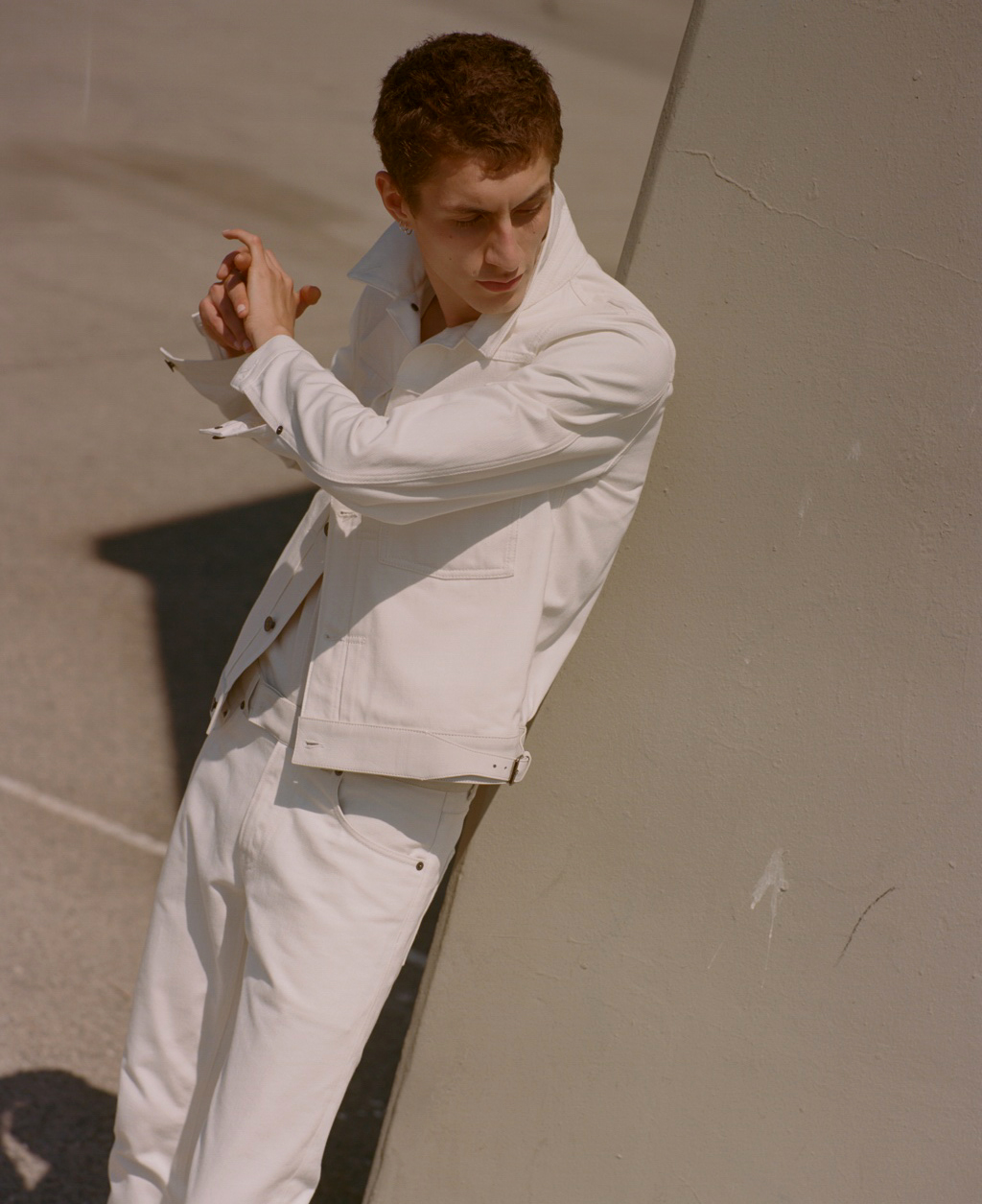 a man leaning against a wall