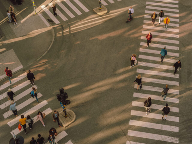 a group of people crossing a street