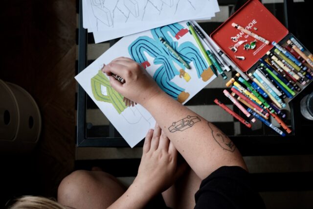 a person drawing on a paper
