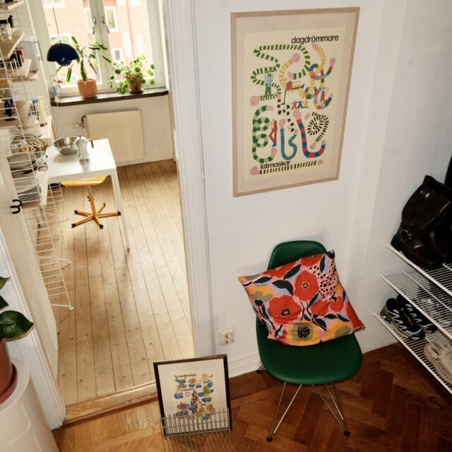 a room with a chair and a painting on the wall