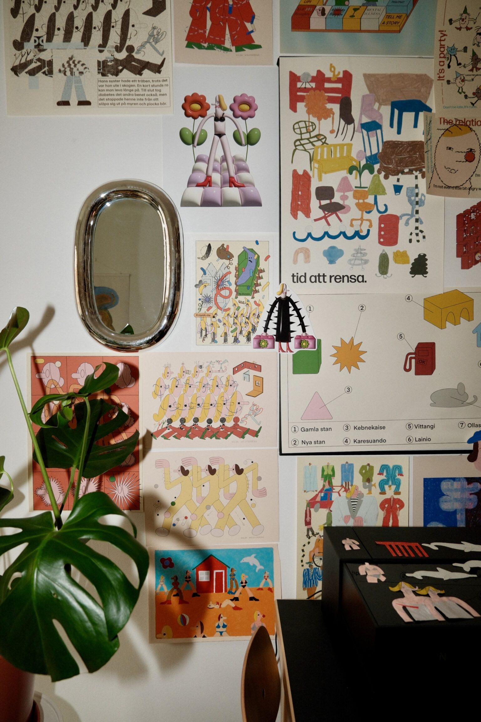 a wall with pictures and a mirror